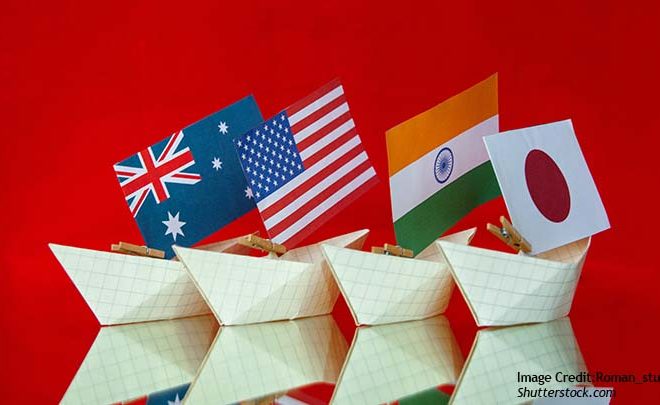 Flags of the quad countries on paper boats